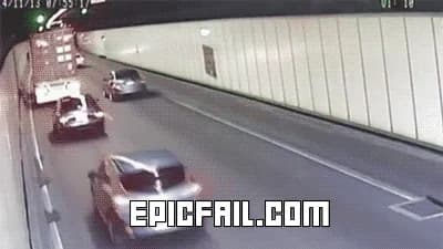 Tunnel security footage shows a truck ripping down the overhead signs and showering debris onto the cars behind it.