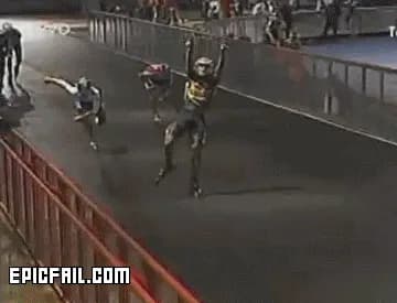 A speed skater throws his arms up to celebrate before the finish line and gets beaten by a rival lunging past him.